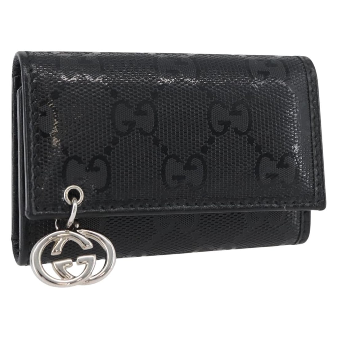 Black PVC GG Canvas Key Holder by Gucci with Silver Accents: Black PVC GG Canvas Key Holder by Gucci with Silver Accents This Gucci key case features the signature GG design in black and silver tones. Crafted from PVC leather and GG canvas, it provides both dur