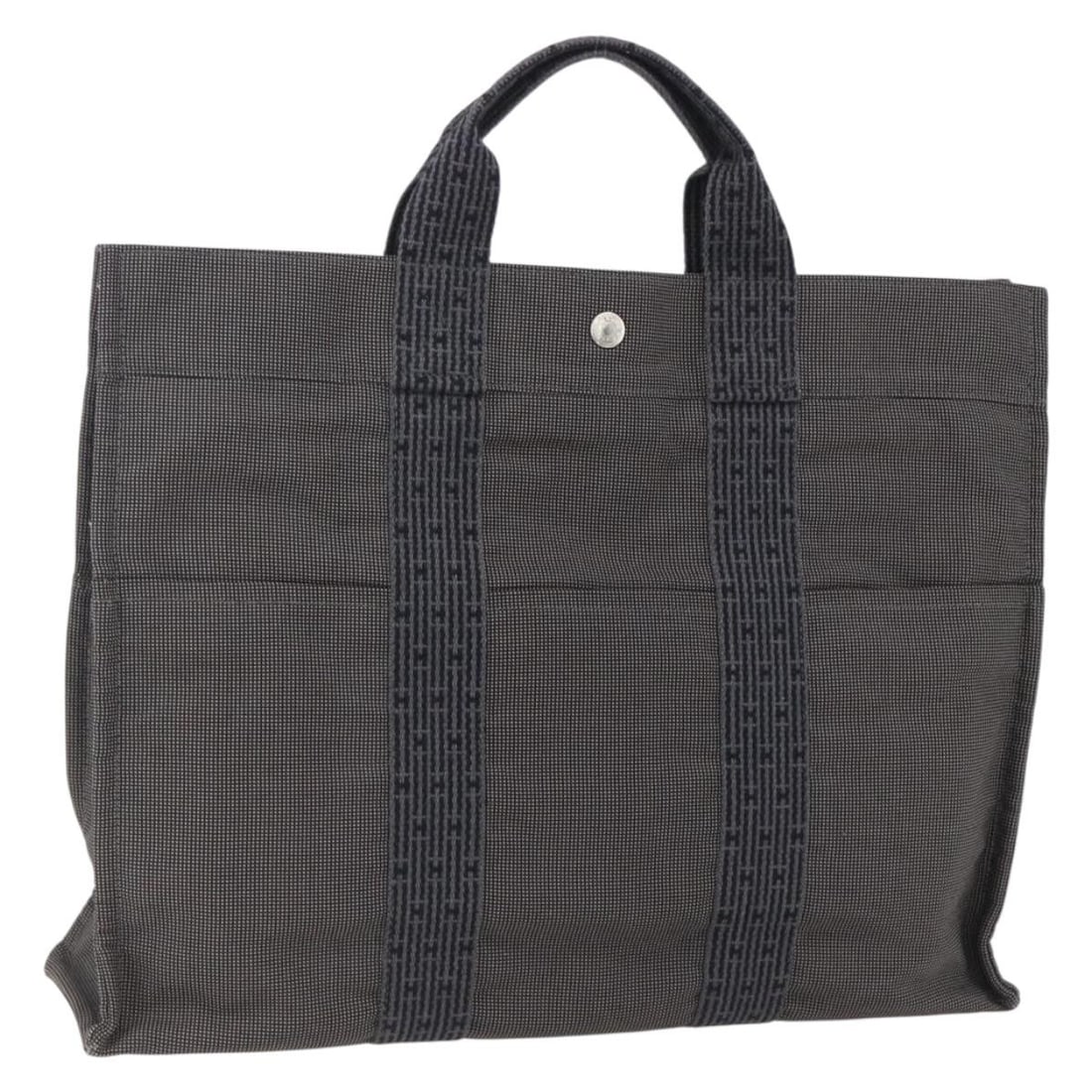 Hermes Her Line MM Canvas Gray Silver Women's Tote Bag: Hermes Her Line MM Canvas Gray Silver Women's Tote Bag This Hermes Her Line Tote MM is a women's handbag crafted from durable canvas in a gray and silver color scheme. The bag features a spacious inte