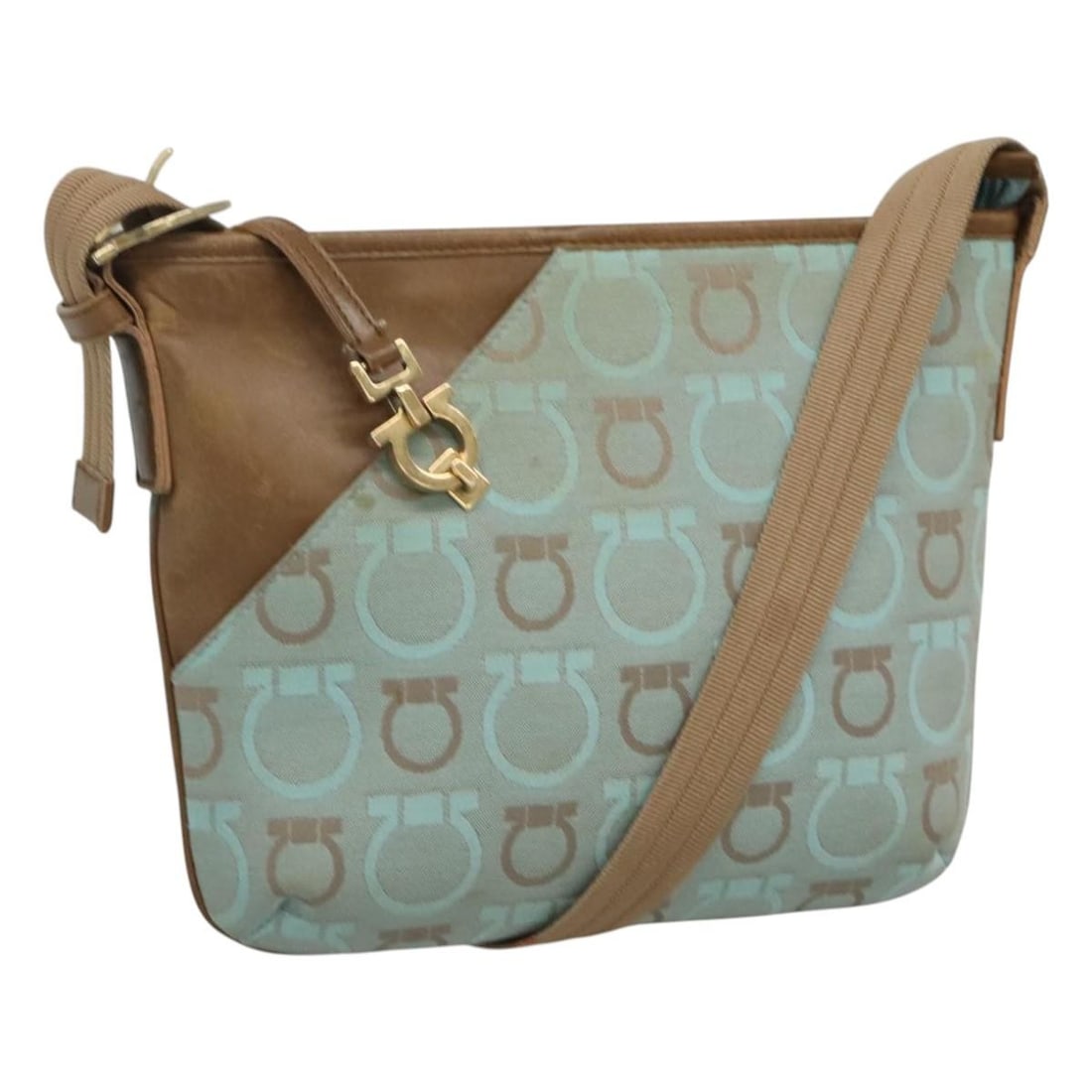 Light Blue Canvas Gancini Shoulder Bag by Salvatore Ferragamo: Light Blue Canvas Gancini Shoulder Bag by Salvatore Ferragamo This Salvatore Ferragamo Gancini shoulder bag features a light blue and beige canvas exterior with gold-tone accents. Designed for women, 