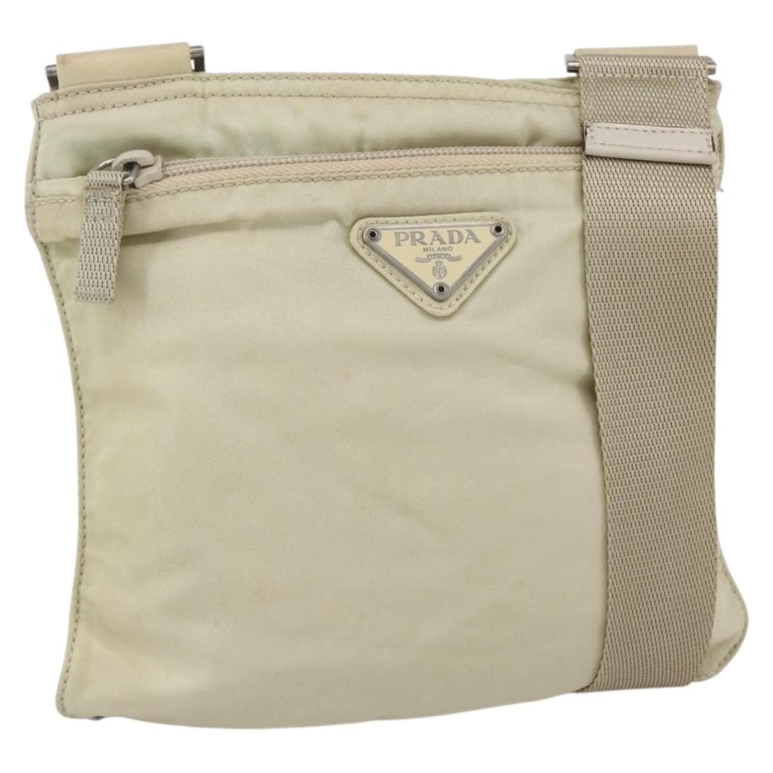Prada beige silver nylon shoulder bag with guarantee card: Prada beige silver nylon shoulder bag with guarantee card This PRADA shoulder bag is crafted from beige nylon with silver-tone accents. Designed for women, the bag features an adjustable shoulder stra