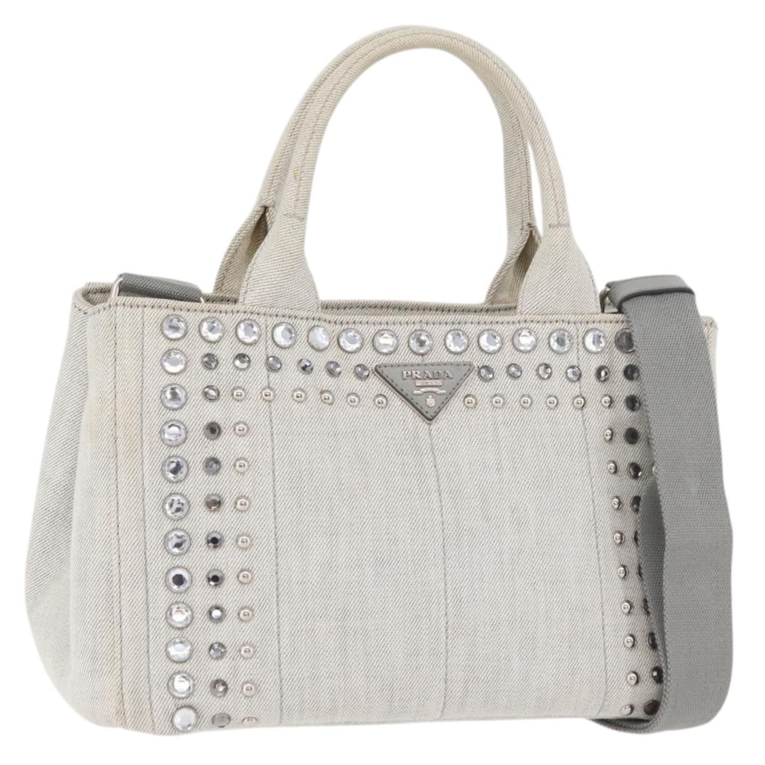 Prada Canapa PM gray silver canvas tote with shoulder strap: Prada Canapa PM gray silver canvas tote with shoulder strap This PRADA Canapa PM is a two-way handbag crafted from gray and silver canvas. Designed for versatility, it features both handles and a deta
