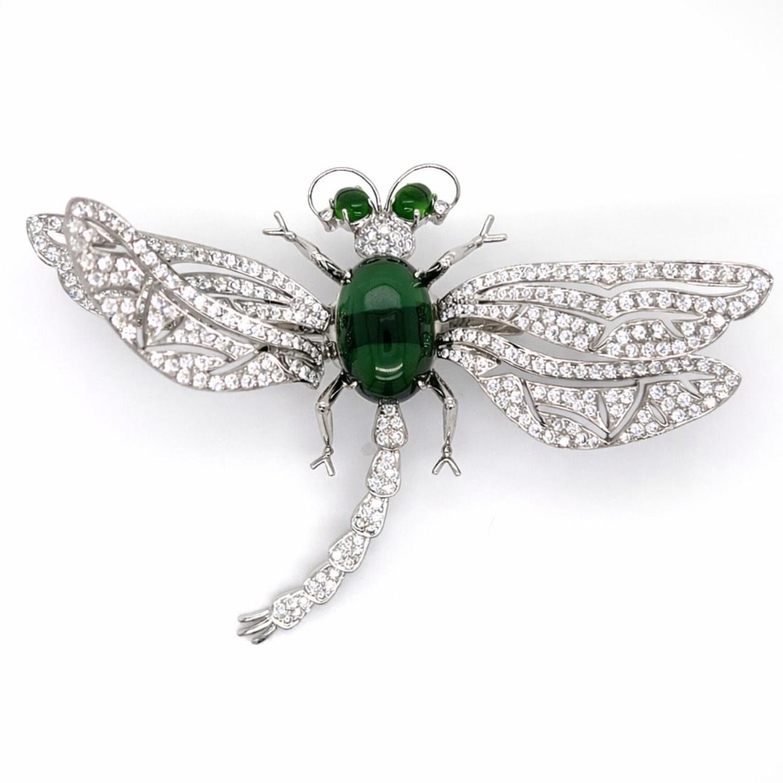 Dragonfly Brooch in 18K White Gold with Diamonds and Tourmalines: Dragonfly Brooch in 18K White Gold with Diamonds and Tourmalines This exquisite dragonfly brooch is crafted in 18K white gold and designed in an entremblant style. It features approximately 300 diamon