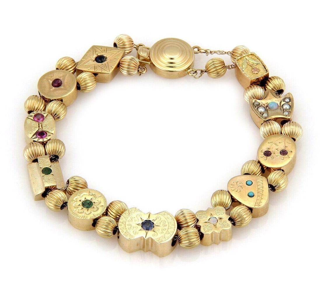 Vintage 14k Yellow Gold Charm Link Bracelet with 11 Slide Charms: Vintage 14k Yellow Gold Charm Link Bracelet with 11 Slide Charms This vintage 14k yellow gold bracelet features 11 slide charms, each set with a colorful selection of gemstones including opal, sapphir