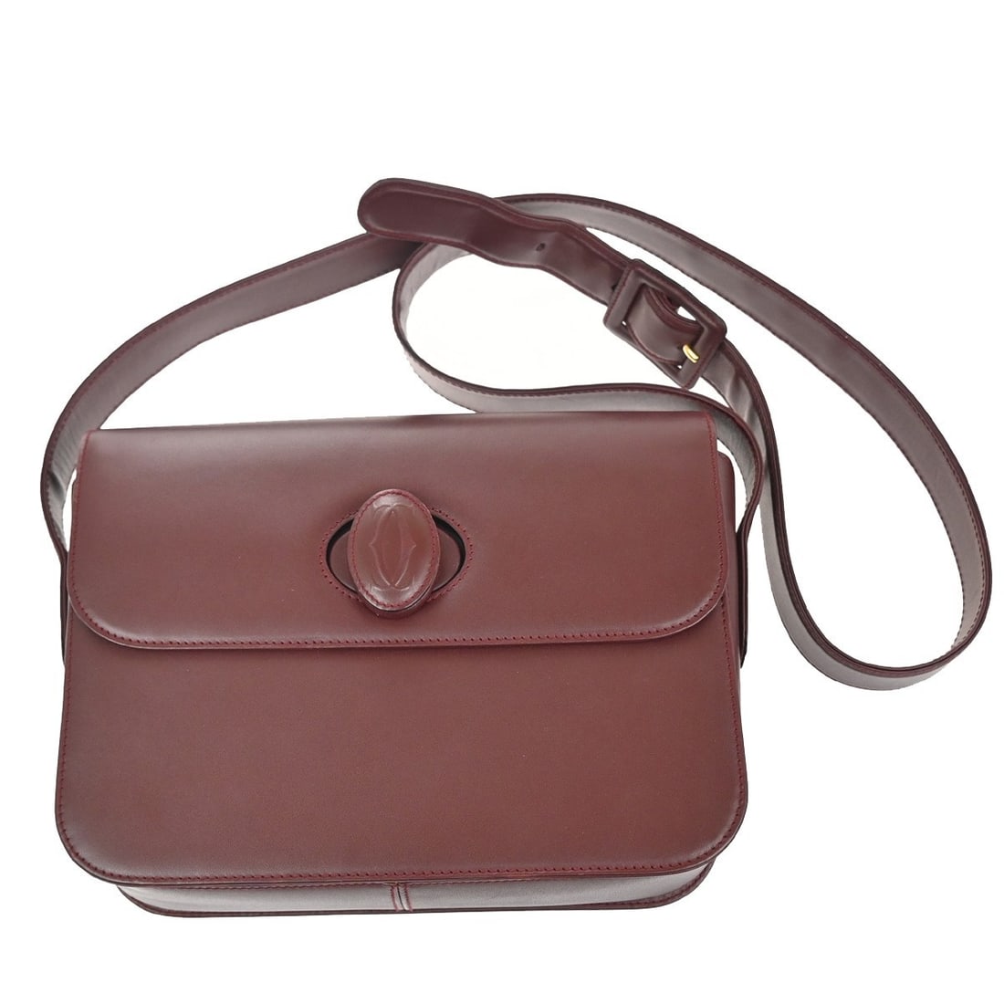 Must de Cartier burgundy leather shoulder bag for women: Must de Cartier burgundy leather shoulder bag for women The Must de Cartier Shoulder Bag is crafted from burgundy leather and is designed for women. This pre-owned bag features noticeable signs of use