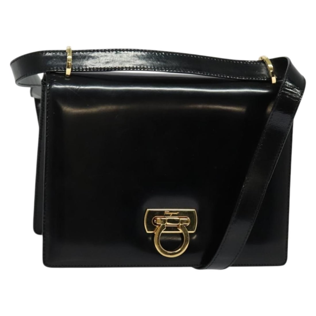 Gancini Patent Leather Shoulder Bag by Salvatore Ferragamo in Black: Gancini Patent Leather Shoulder Bag by Salvatore Ferragamo in Black This Salvatore Ferragamo Gancini shoulder bag is crafted from black patent leather and designed for women. Made in Italy, it feature