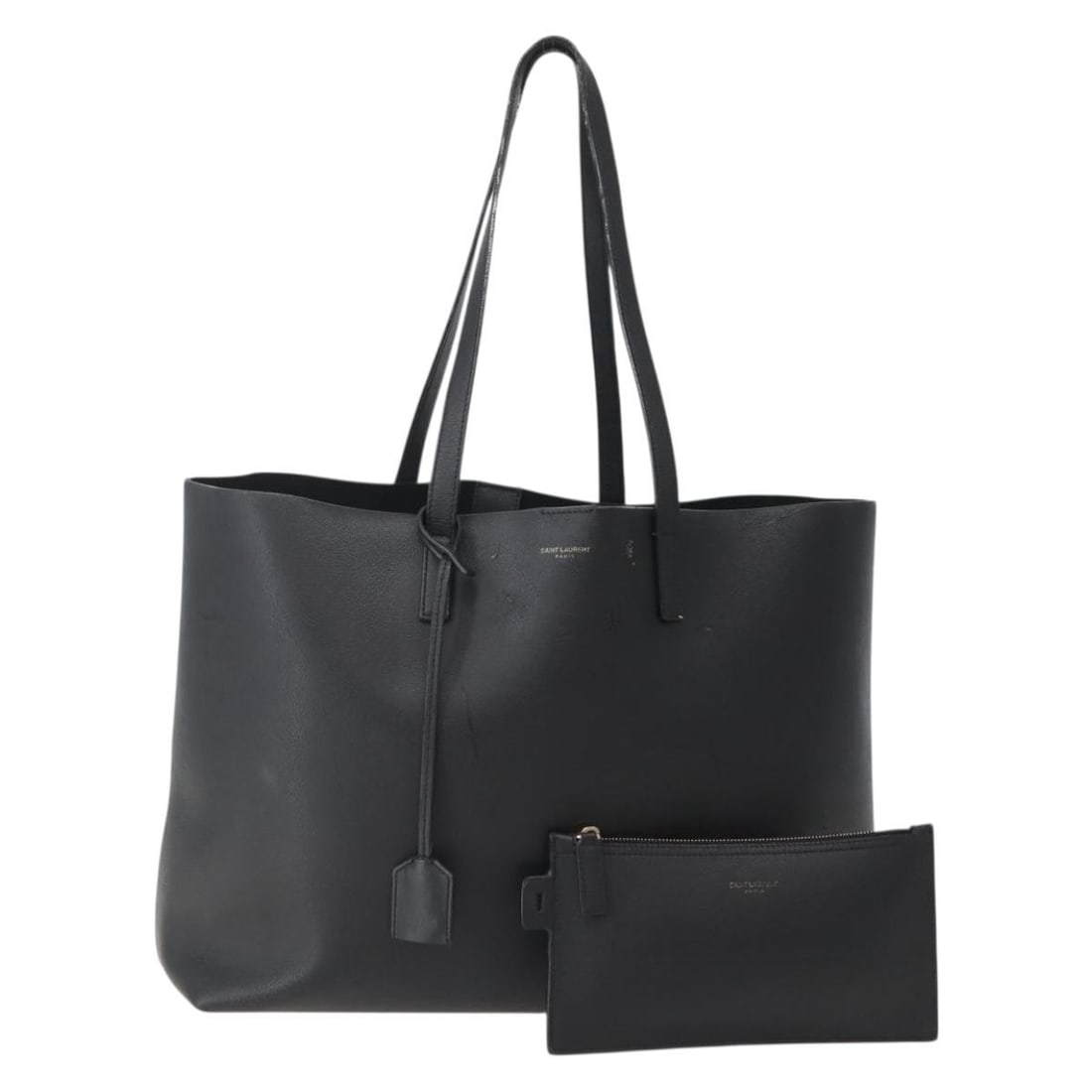 Black Leather Saint Laurent Tote with Pouch: Black Leather Saint Laurent Tote with Pouch This SAINT LAURENT tote bag is crafted from black leather and made in Italy. It features dual handles and comes with a pouch accessory. The bag has visible 