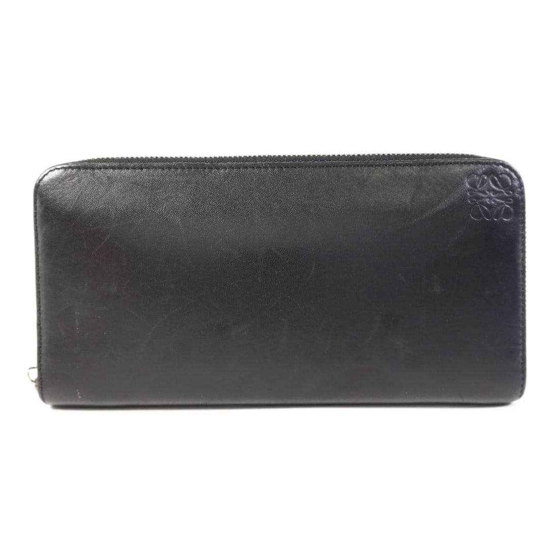 Black Calfskin Leather Long Round Wallet by LOEWE with Silver Hardware: Black Calfskin Leather Long Round Wallet by LOEWE with Silver Hardware This LOEWE long round wallet features premium black calfskin leather and a secure zip-around design. Crafted in Spain, it is desi