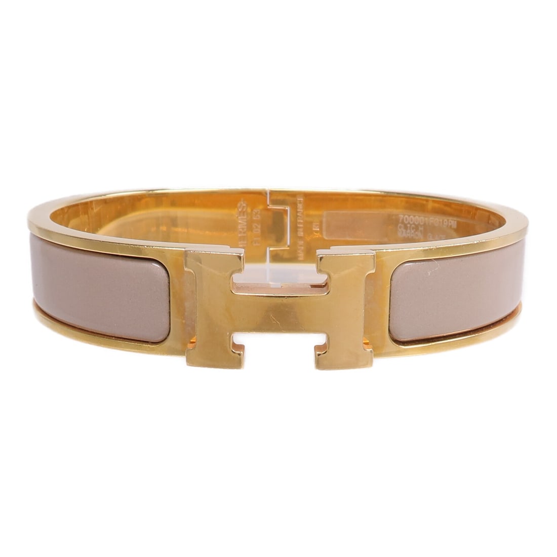 Hermes Clic H enamel bangle in beige gold tone: Hermes Clic H enamel bangle in beige gold tone This Hermes Clic H bracelet features a beige enamel finish with gold-tone accents, offering a sophisticated and timeless accessory for women. Crafted in 