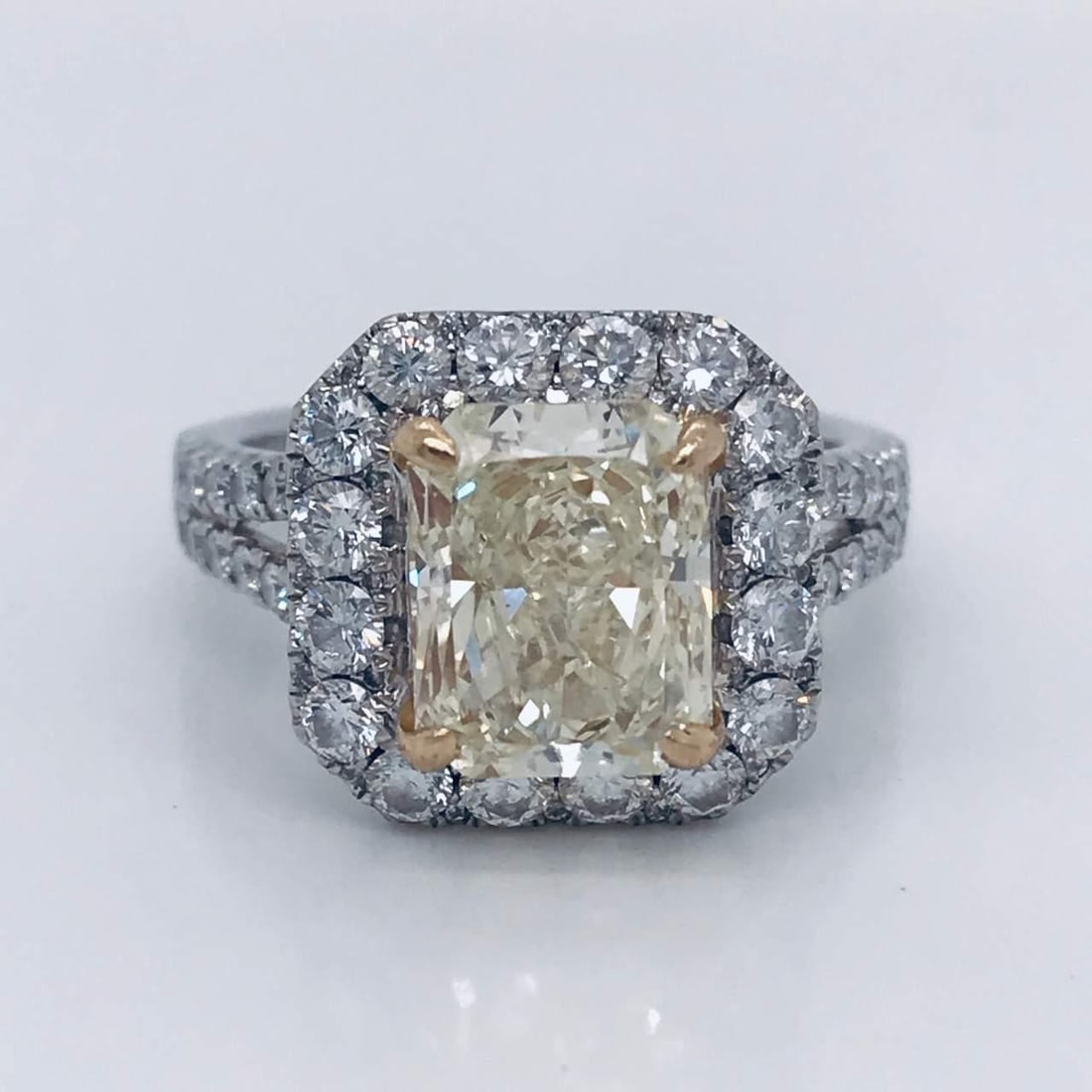 3.06 Ct Fancy Light Yellow Diamond Engagement Ring in 18K White Gold: 3.06 Ct Fancy Light Yellow Diamond Engagement Ring in 18K White Gold This stunning engagement ring features a remarkable 3.06 Ct radiant cut fancy light yellow diamond with VVS clarity. The diamond is