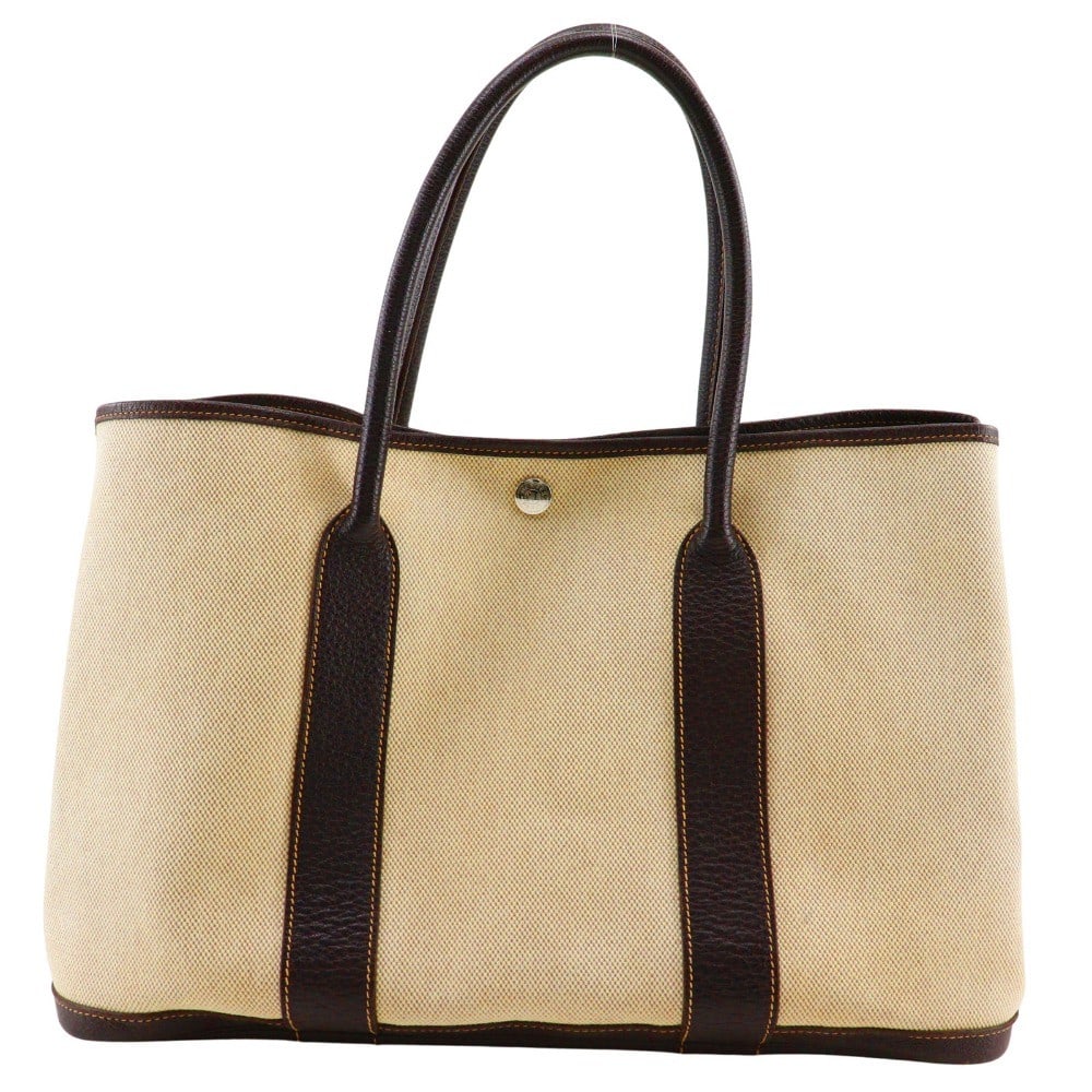 Hermes Garden Party Brown Canvas Tote Bag 36cm by 24cm by 17cm: Hermes Garden Party Brown Canvas Tote Bag 36cm by 24cm by 17cm This Hermes Garden Party Tote for women features a brown canvas exterior with leather accents. It is designed with practical dimensions s