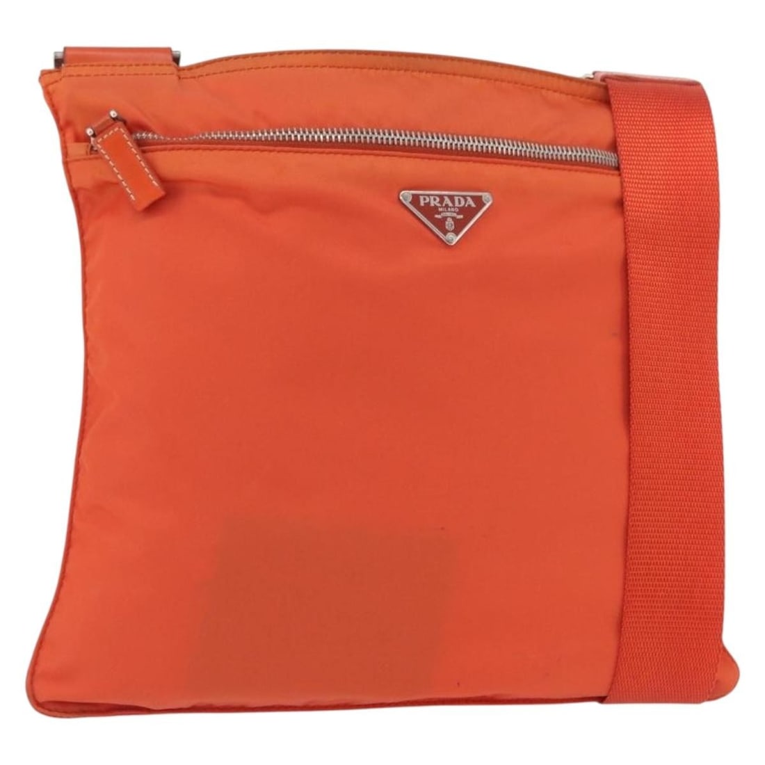 Orange Nylon PRADA Shoulder Bag with Silver Accents and Guarantee Card: Orange Nylon PRADA Shoulder Bag with Silver Accents and Guarantee Card This PRADA shoulder bag features a vibrant orange and silver nylon exterior, designed for women. The bag offers a practical size 