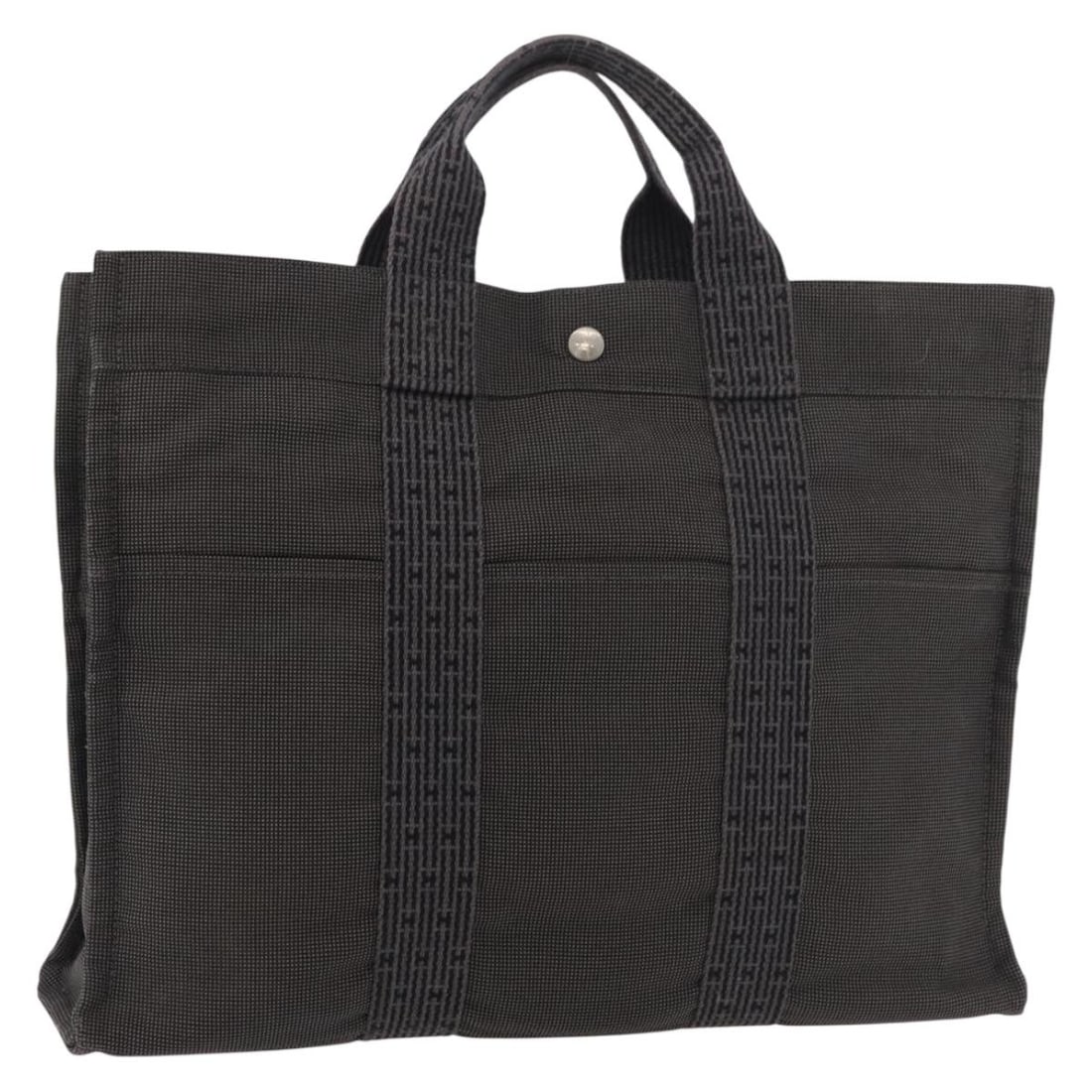 Hermes Her Line MM Gray Silver Canvas Handbag: Hermes Her Line MM Gray Silver Canvas Handbag This Hermes Her Line MM handbag is crafted from gray and silver canvas, offering a stylish and practical accessory for everyday use. The bag features a