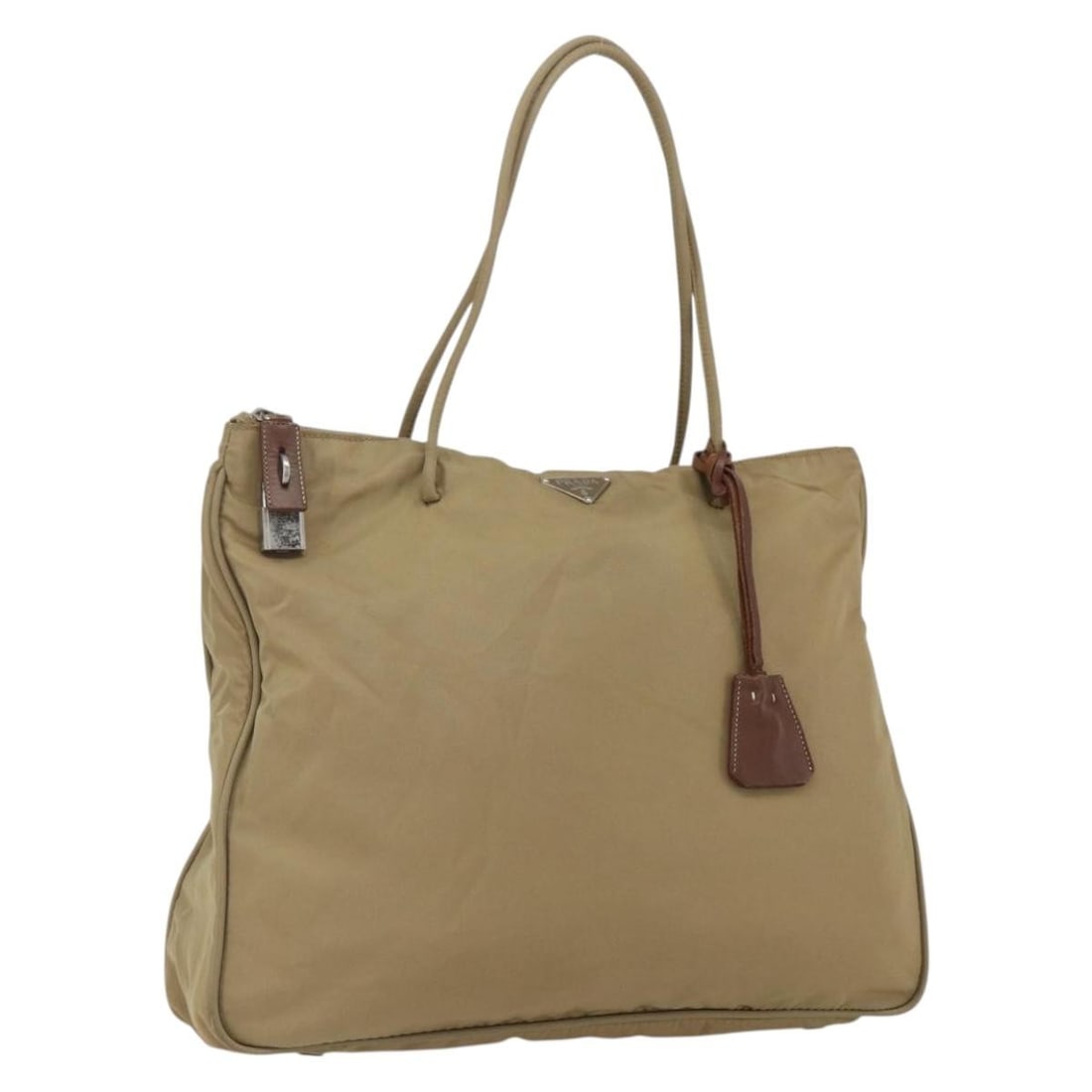 Prada beige silver nylon tote with padlock key and clochette: Prada beige silver nylon tote with padlock key and clochette This PRADA tote bag is crafted from beige nylon with silver-tone accents, offering a practical and stylish accessory. Designed for women, i