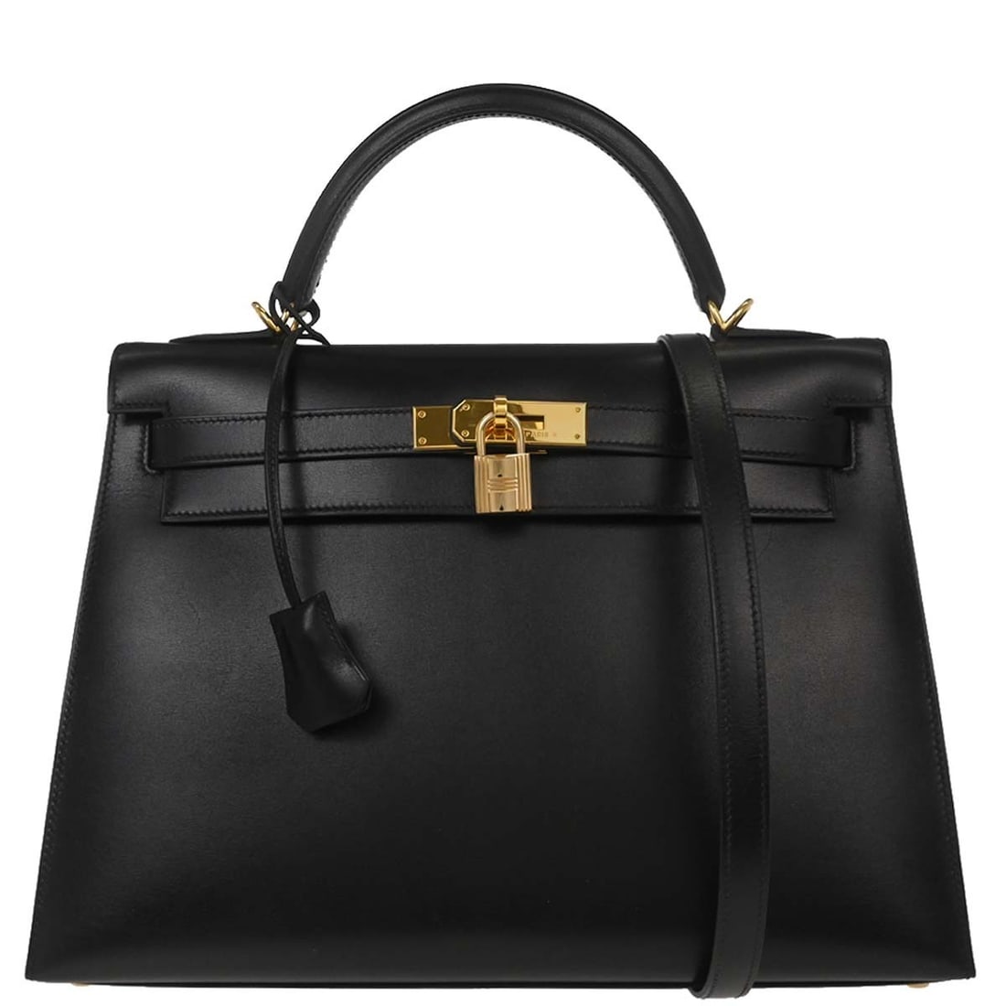 Black Leather Kelly 32 Top Handle Bag with Gold Hardware by Hermes: Black Leather Kelly 32 Top Handle Bag with Gold Hardware by Hermes This Hermes Kelly 32 Sellier handbag is crafted from black box calf leather and features gold-tone hardware. The medium-sized bag inc