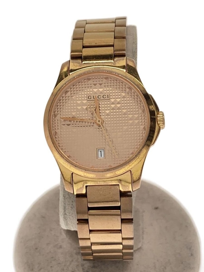 Gucci G Timeless Gold Tone Quartz Ladies Wristwatch: Gucci G Timeless Gold Tone Quartz Ladies Wristwatch This GUCCI G-TIMELESS Quartz 126.5 women's wristwatch features a gold-tone stainless steel case and band. Designed in Switzerland, it offers a class