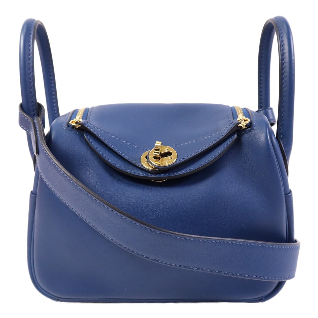 Hermes Mini Lindy Navy Swift Leather Shoulder Bag with Gold Hardware: Hermes Mini Lindy Navy Swift Leather Shoulder Bag with Gold Hardware This Hermes Mini Lindy 2-way shoulder bag is crafted from Swift calfskin leather in a deep navy blue color. Designed for women, it 