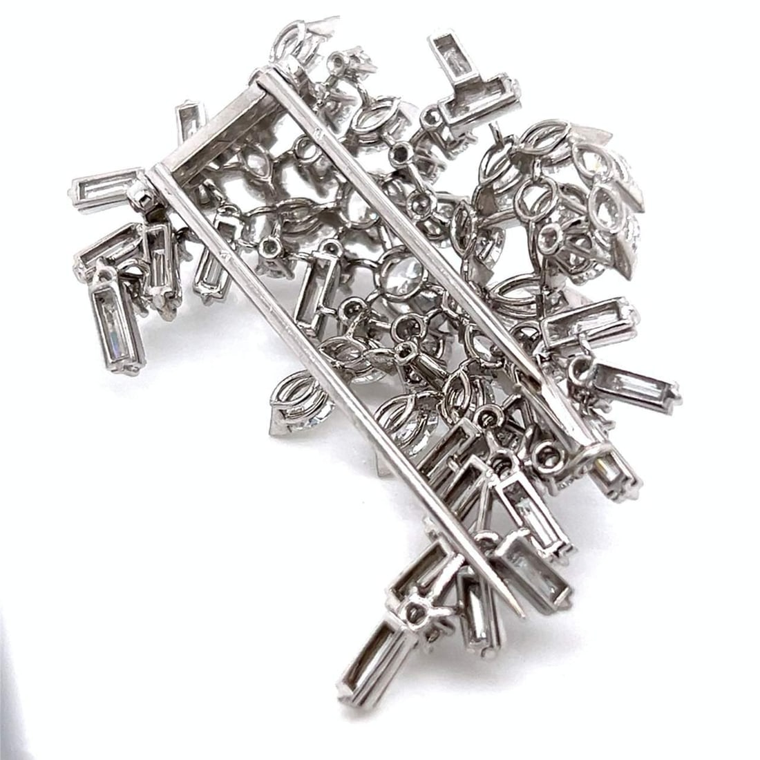 1960's 18K White Gold Diamond Brooch 10.50 Ct 64 Diamonds F-G VVS-VS: 1960's 18K White Gold Diamond Brooch 10.50 Ct 64 Diamonds F-G VVS-VS This exquisite 1960's brooch is crafted from 18K white gold and features a stunning arrangement of 64 diamonds, totaling approximat