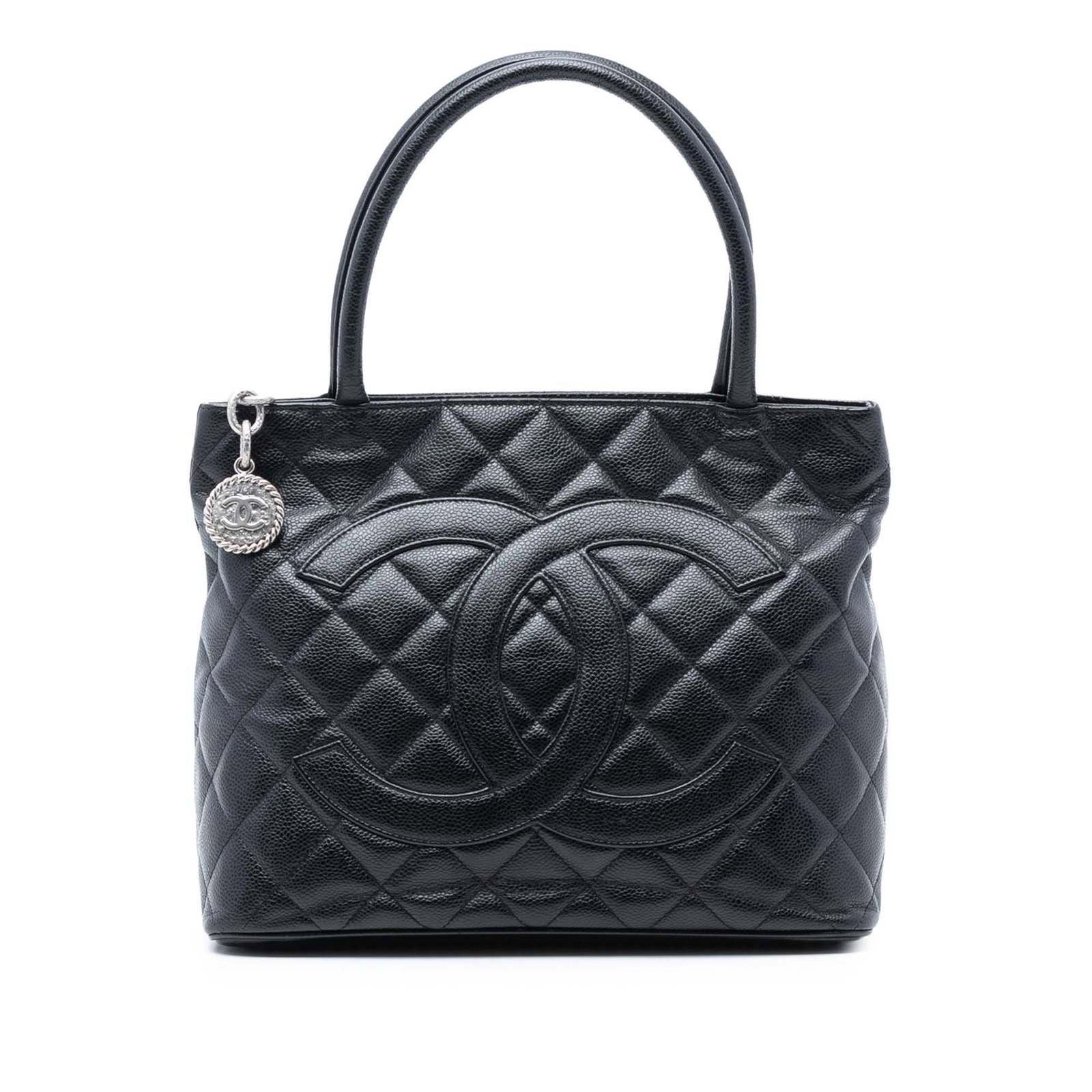 Black Caviar Leather Medallion Tote Bag by Chanel: Black Caviar Leather Medallion Tote Bag by Chanel This Chanel Caviar Medallion Tote features a quilted caviar leather exterior in black, rolled leather handles, a top zip closure, an exterior back sli