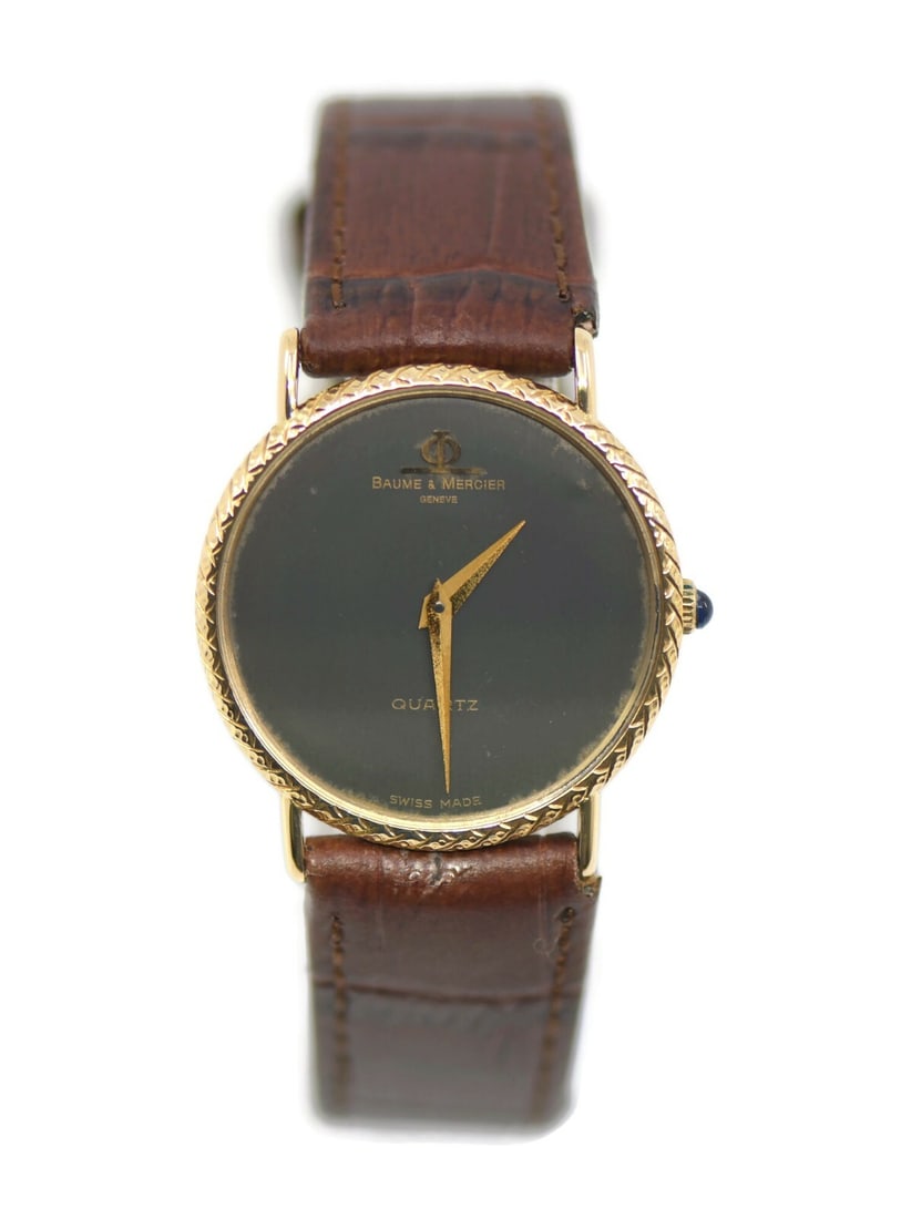 Baume & Mercier 18K Yellow Gold Quartz Watch Model 15138 with Box: Baume & Mercier 18K Yellow Gold Quartz Watch Model 15138 with Box This exquisite Baume & Mercier wristwatch showcases a luxurious design crafted from 18K yellow gold. Featuring a sleek black dial and 