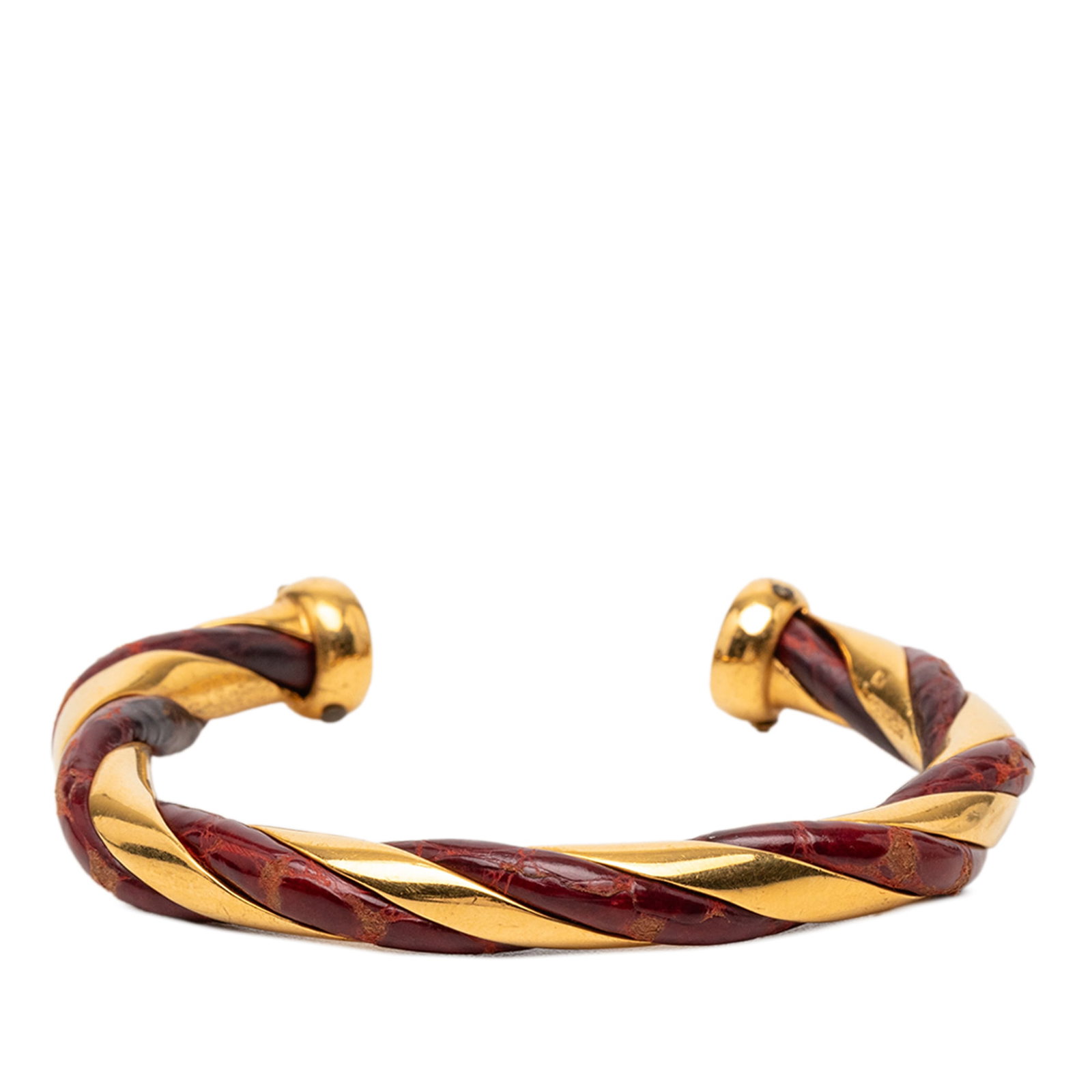 Hermes Twisted Cuff Bracelet Gold Plated Metal With Leather Accent: Hermes Twisted Cuff Bracelet Gold Plated Metal With Leather Accent This Hermes cuff bracelet features a twisted gold-tone metal body combined with leather accents. The bracelet is classified as costum