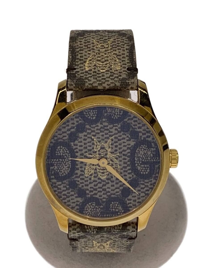 Gucci G Timeless Quartz Women's Brown Wristwatch 126.4: Gucci G Timeless Quartz Women's Brown Wristwatch 126.4 This is a pre-owned Gucci G-Timeless Quartz 126.4 women's wristwatch, crafted in Switzerland. The watch features a brown color scheme and is in s