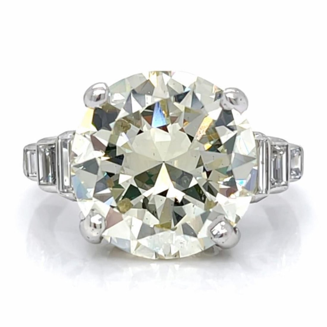 Platinum Art Deco Ring with 8.17 Carat European-Cut Diamond: Platinum Art Deco Ring with 8.17 Carat European-Cut Diamond This Art Deco platinum ring features a prominent 8.17 carat European-cut diamond with M color and VS2 clarity. The centerpiece is complement