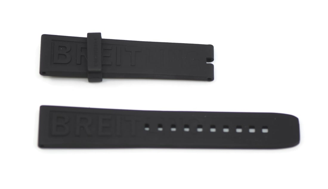 Authentic Breitling Black Rubber Wristwatch Band 20mm: Authentic Breitling Black Rubber Wristwatch Band 20mm This authentic Breitling wristwatch band is crafted from durable black rubber, ensuring both comfort and longevity. With a band width of 20 mm, it