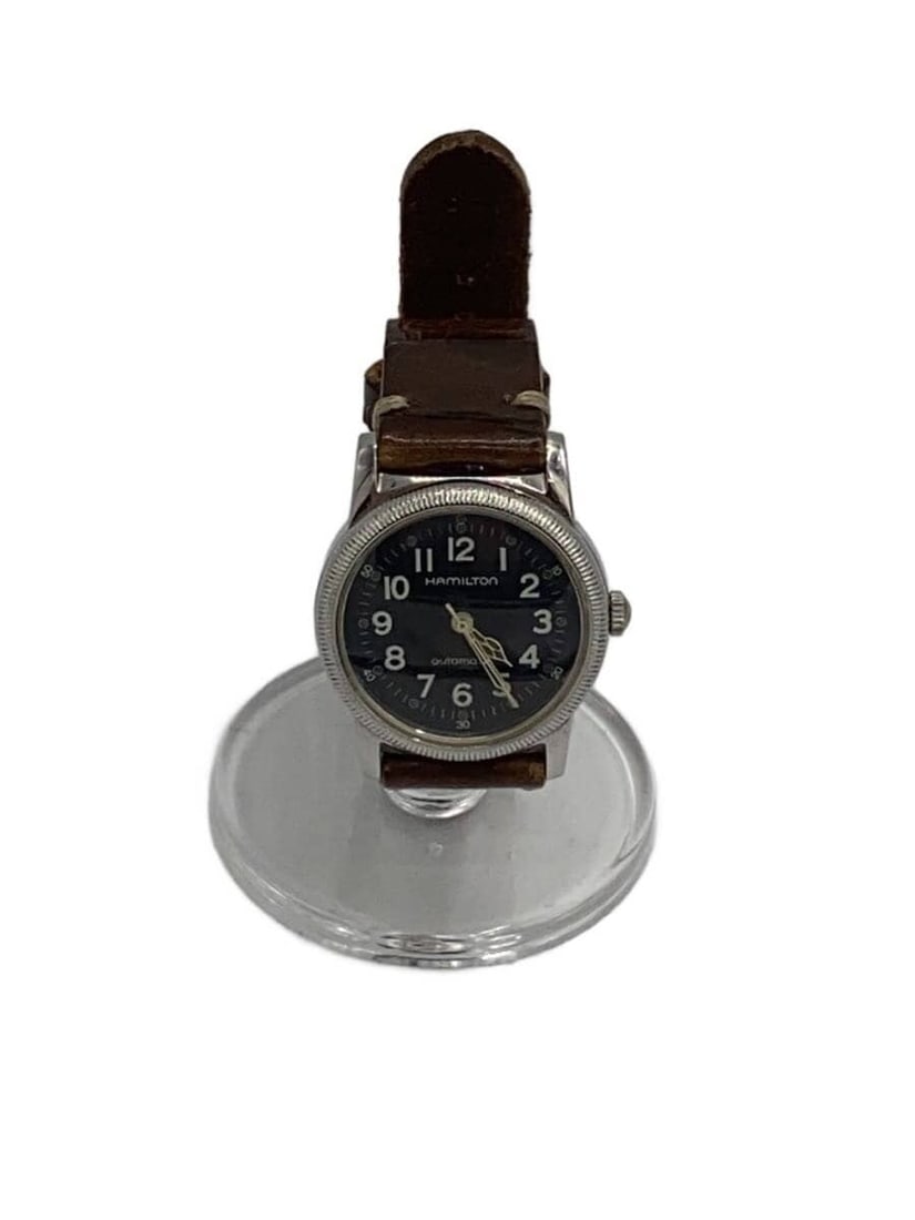 Hamilton 9789 men's military leather wristwatch: Hamilton 9789 men's military leather wristwatch This Hamilton Military Watch 9789 is a men's wristwatch featuring a black dial and a leather band. Made in Switzerland, it exhibits slight signs of wear