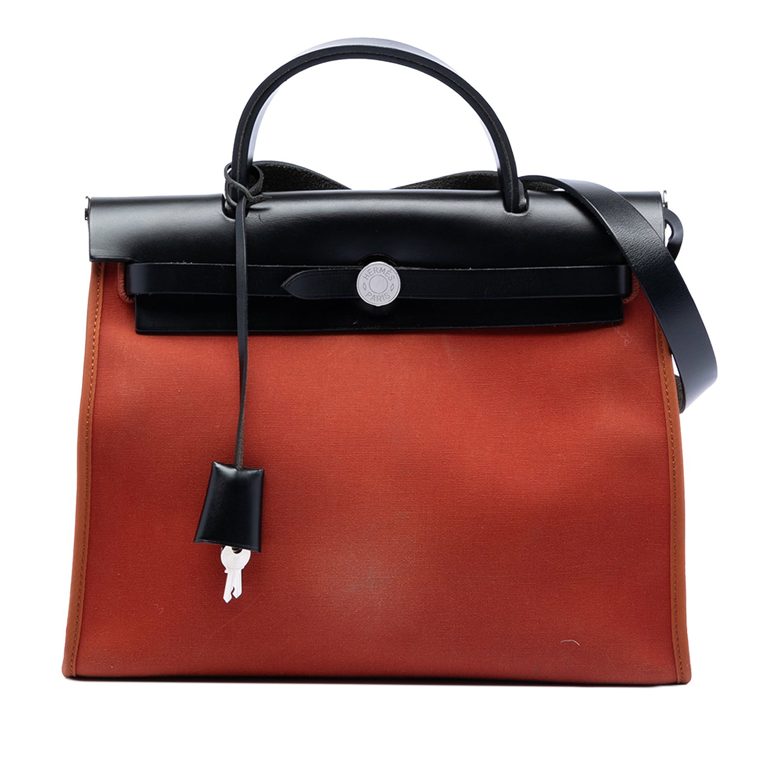 Herbag Zip 31 Orange Canvas and Leather Shoulder Bag by Hermes: Herbag Zip 31 Orange Canvas and Leather Shoulder Bag by Hermes The Hermes Toile Herbag Zip 31 is crafted with an orange canvas body accented by leather trim. It features a clochette, a flat leather to