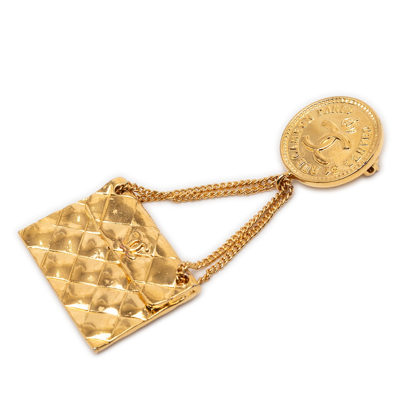 Chanel Quilted Flap Bag Medallion CC Gold Tone Brooch: Chanel Quilted Flap Bag Medallion CC Gold Tone Brooch This Chanel brooch features a gold tone metal body with a quilted flap bag medallion design and a back pin closure. It is categorized as a costume