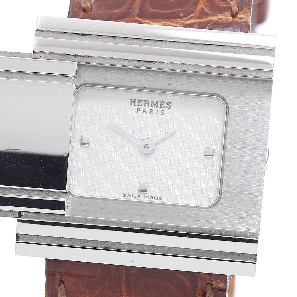 Hermes Glizard Quartz Ladies Stainless Steel Wristwatch: Hermes Glizard Quartz Ladies Stainless Steel Wristwatch This pre-owned HERMES Glissard GL1.510 women's wristwatch features a stainless steel case paired with a leather strap. The watch is powered by a