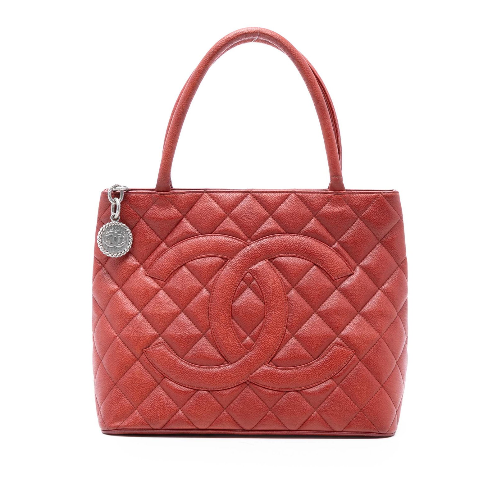 Red Caviar Leather Medallion Tote Bag by Chanel: Red Caviar Leather Medallion Tote Bag by Chanel This Chanel Caviar Medallion Tote features a quilted caviar leather body in red, rolled leather handles, a top zip closure, an exterior back slip pocket