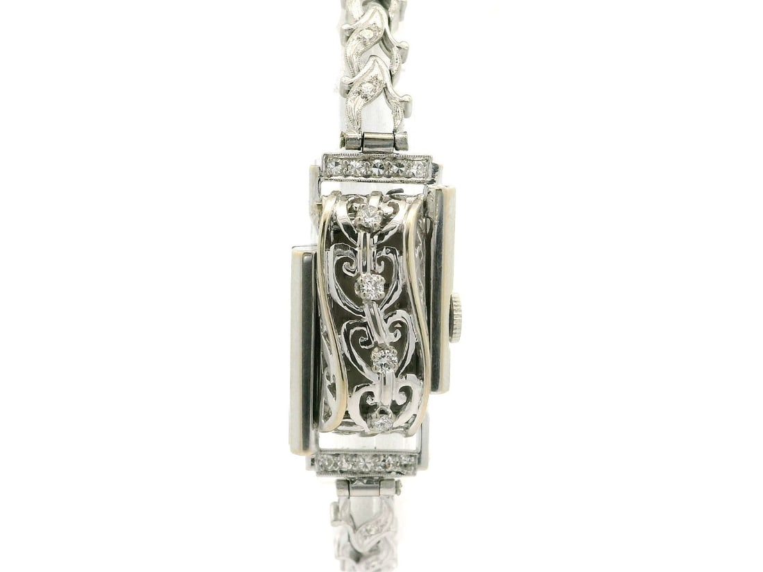 Jaeger-LeCoultre 14k Gold Diamond Floral Link Bracelet Watch: Jaeger-LeCoultre 14k Gold Diamond Floral Link Bracelet Watch This exquisite Vintage Fancy LeCoultre wristwatch showcases a stunning 14k white gold hidden design adorned with a diamond floral leaf link