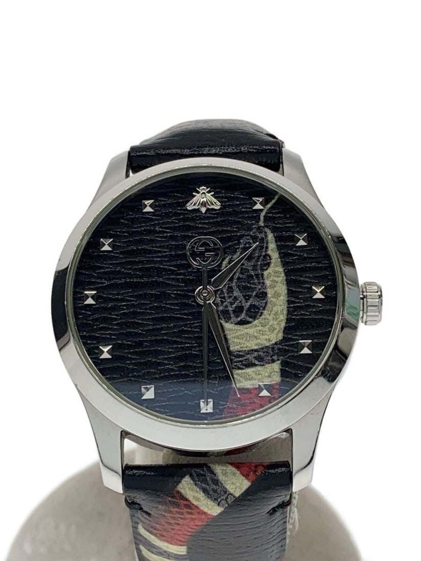 Gucci G Timeless Quartz Black Men's Wristwatch: Gucci G Timeless Quartz Black Men's Wristwatch This is a pre-owned Gucci G-Timeless Quartz 126.4 men's wristwatch. The watch features a black dial and is crafted with Swiss precision. It shows slight 