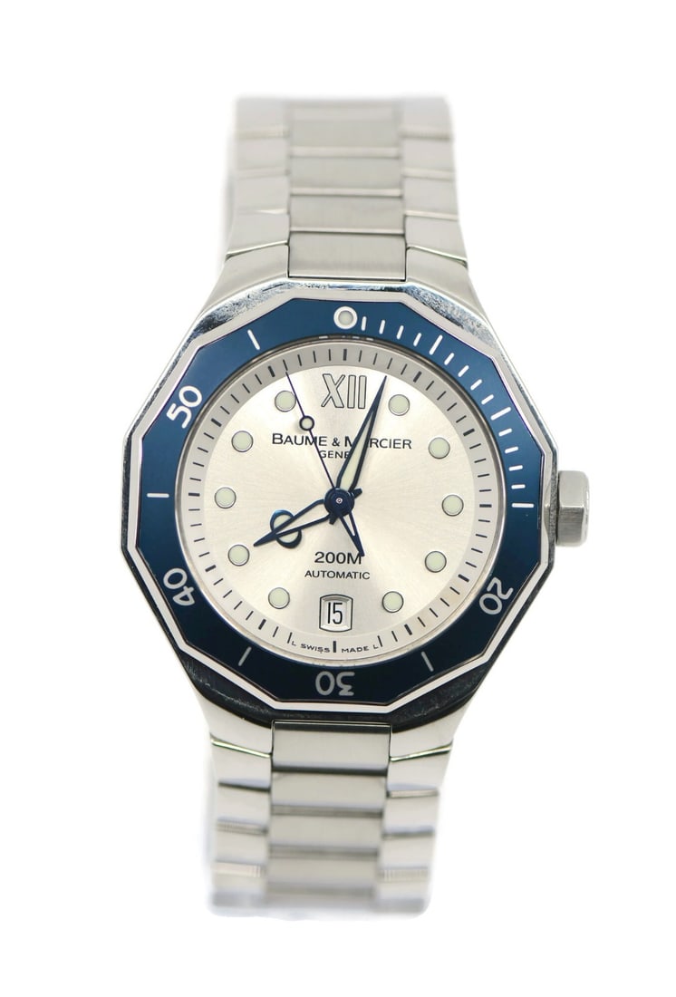 Riviera MOA08779 Stainless Steel Automatic Men's Wristwatch with Box and Papers: Riviera MOA08779 Stainless Steel Automatic Men's Wristwatch with Box and Papers This Baume & Mercier Riviera wristwatch features a stainless steel case and band, a silver analog dial, and an automatic