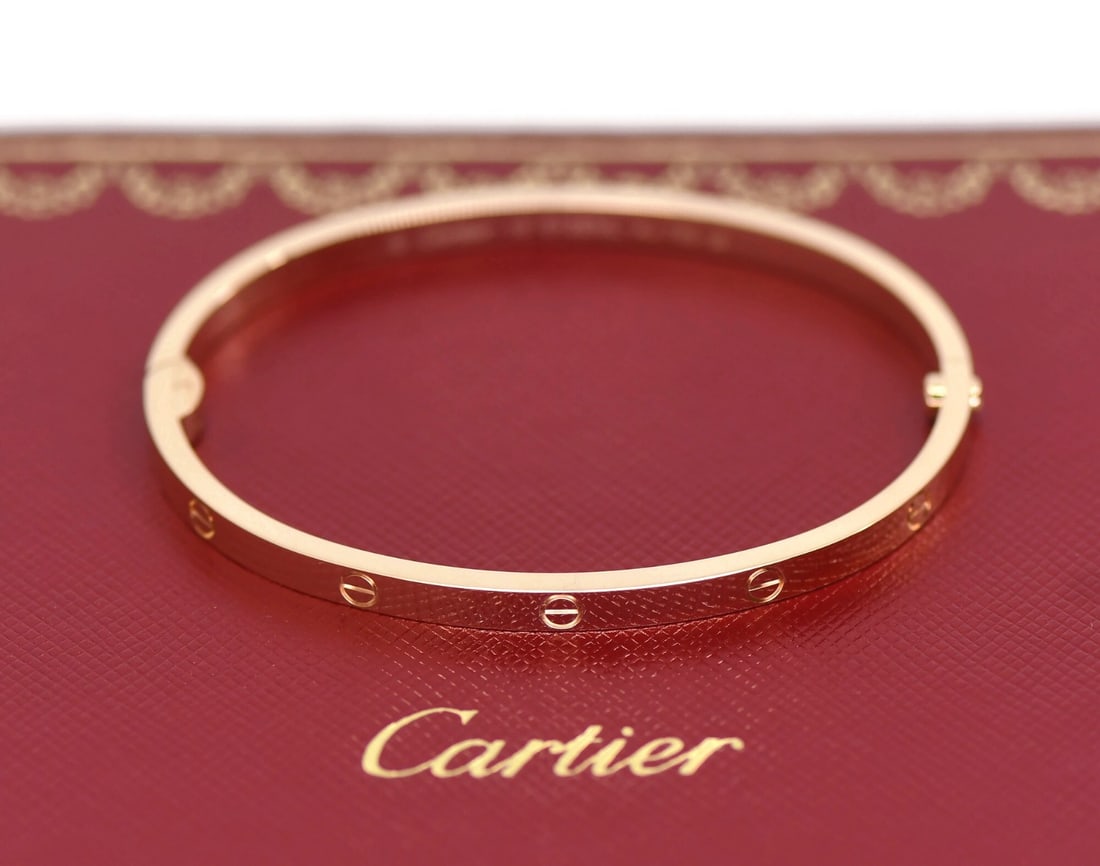 Cartier Love Bangle 18K Rose Gold Size 16: Cartier Love Bangle 18K Rose Gold Size 16 This Cartier Love Bracelet is crafted from 18K rose gold in the small model design, featuring a bangle style and a width of 3.6mm. It comes in size 16 and is 