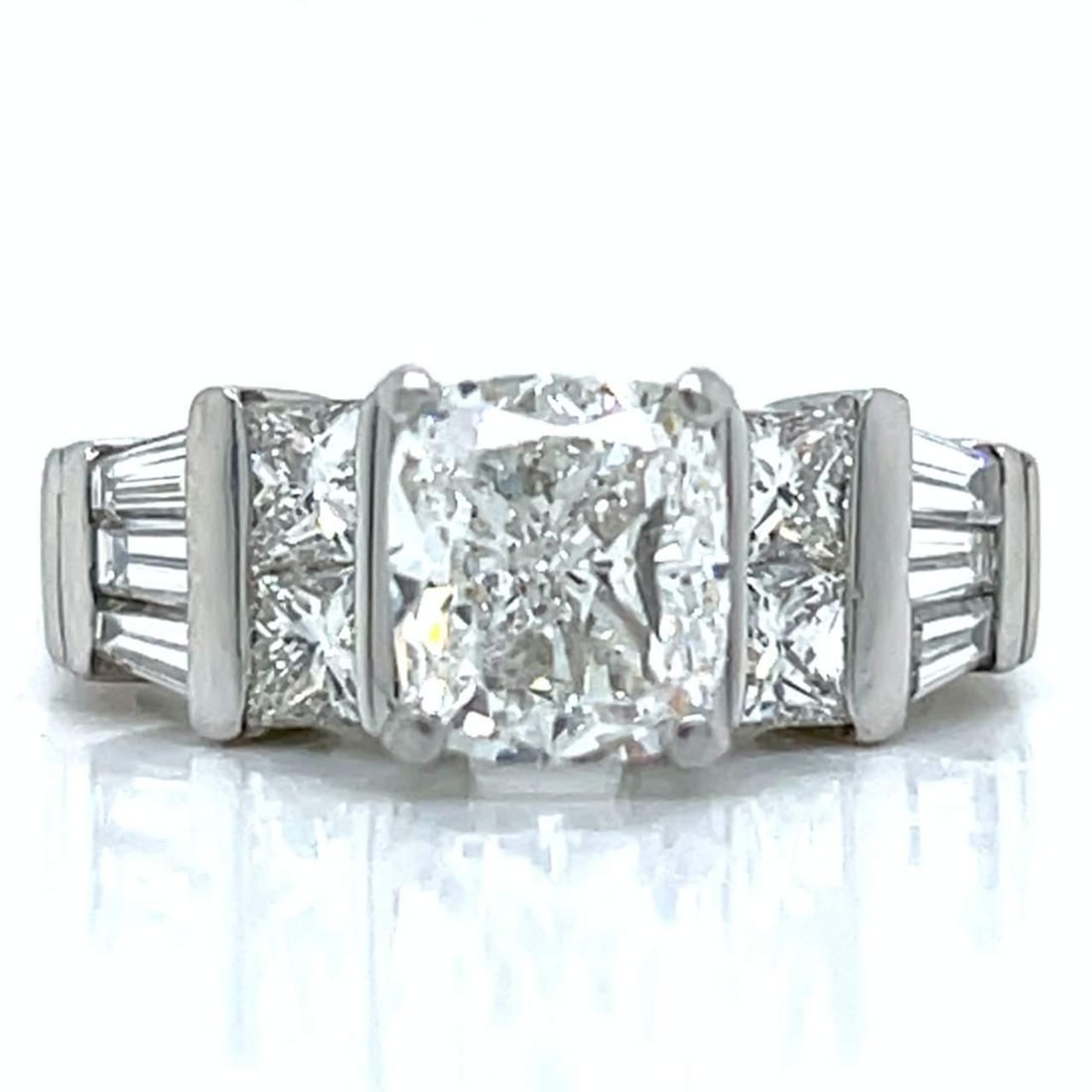 Platinum Diamond Ring 1.81 Ct. Cushion-cut G VS2 with 10 Diamonds: Platinum Diamond Ring 1.81 Ct. Cushion-cut G VS2 with 10 Diamonds This exquisite platinum ring features a stunning 1.81 Ct. cushion-cut diamond, showcasing a G color and VS2 clarity. The ring is adorn