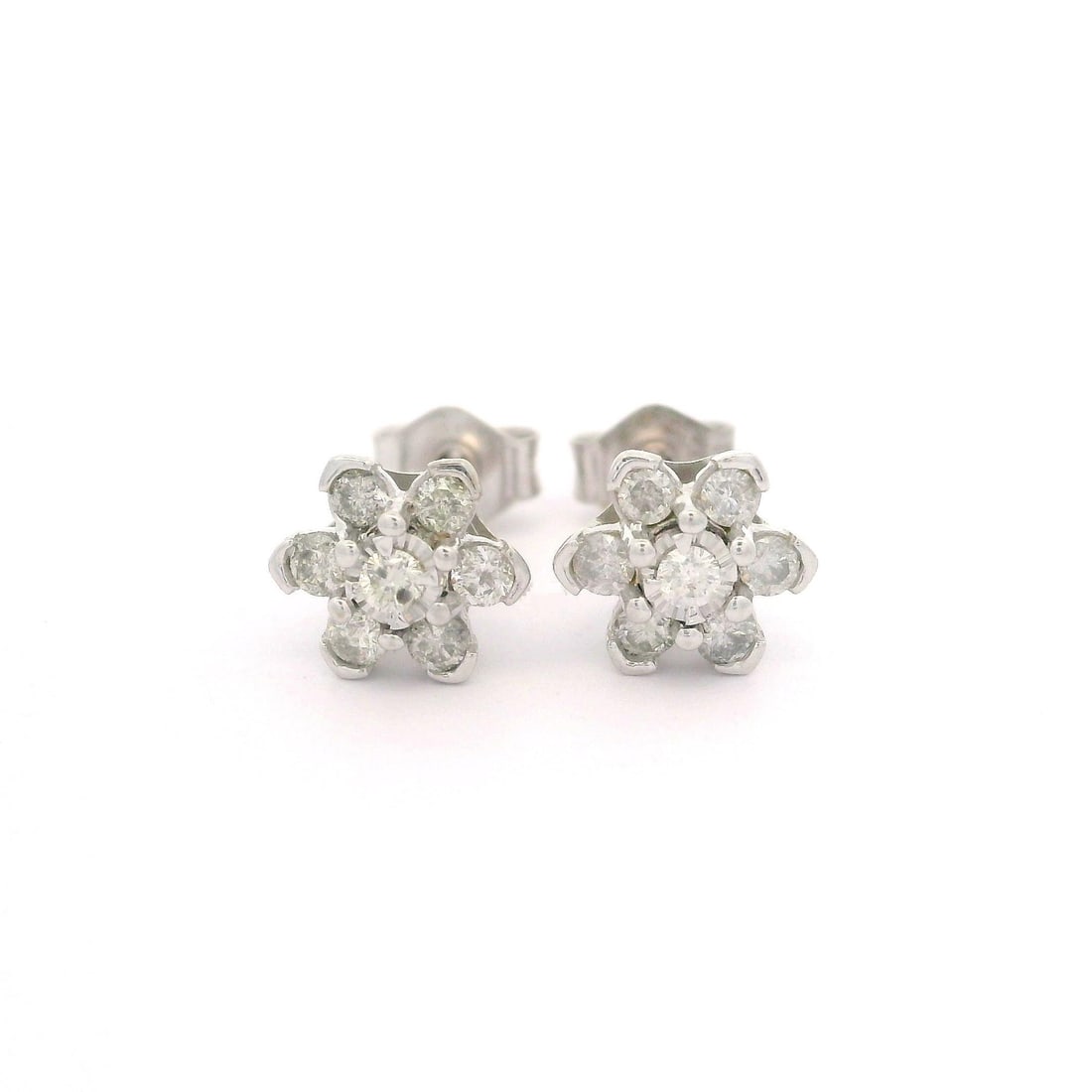 10k White Gold 0.25ctw Diamond Flower Cluster Stud Earrings: 10k White Gold 0.25ctw Diamond Flower Cluster Stud Earrings These exquisite stud earrings are crafted from solid 10k white gold and feature a charming petite flower cluster design. Each earring showca