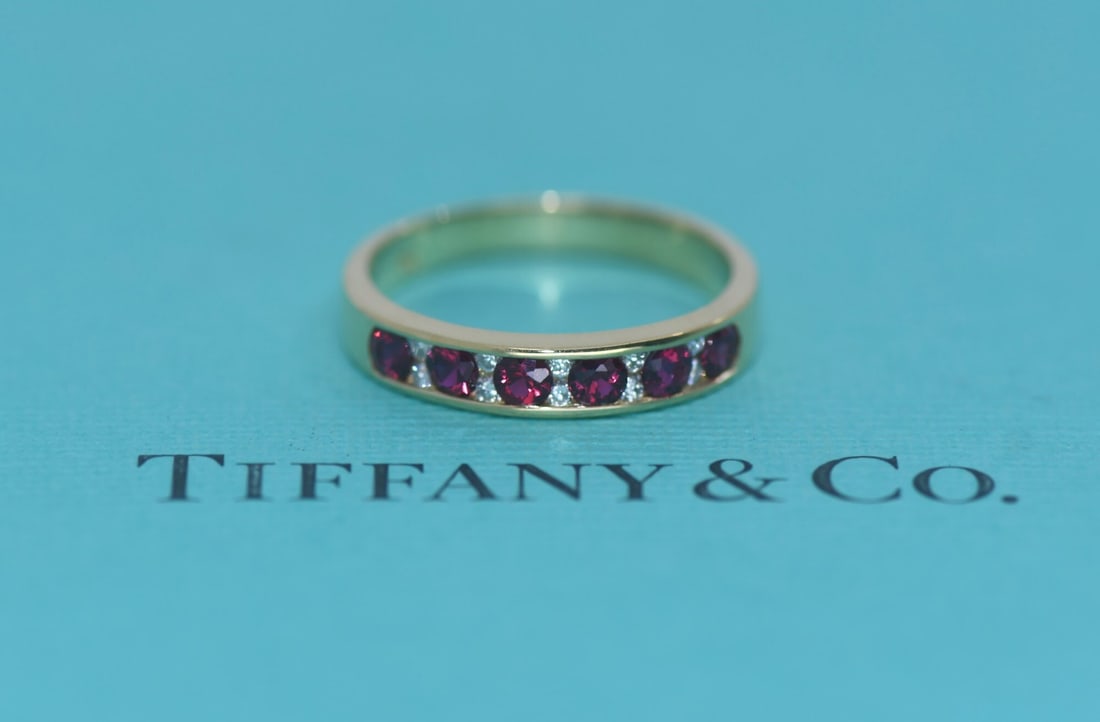 Tiffany & Co 18K Yellow Gold Ruby Diamond Ring Size 7.25: Tiffany & Co 18K Yellow Gold Ruby Diamond Ring Size 7.25 This Tiffany & Co. ring features a sophisticated design crafted from 18K yellow gold. The ring is adorned with both diamonds and rubies, offeri