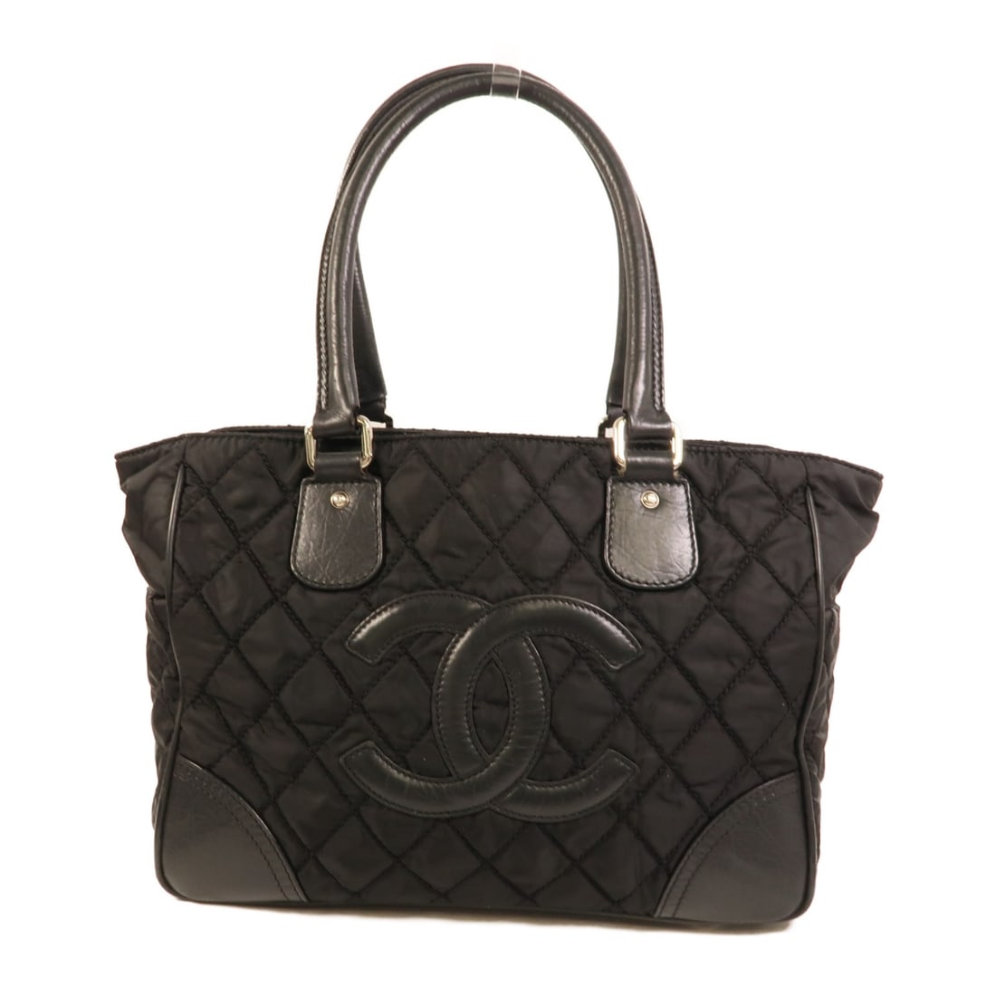 CHANEL Black Nylon Paris New York Tote Bag: CHANEL Black Nylon Paris New York Tote Bag This CHANEL Paris New York tote bag is crafted from black nylon and features the iconic CC logo. Designed for women, it offers a spacious interior suitable f