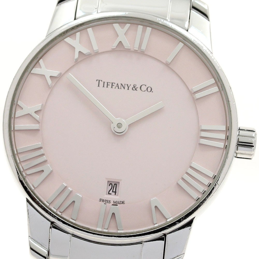 Tiffany Atlas Dome Quartz Ladies Date Watch 35188576: Tiffany Atlas Dome Quartz Ladies Date Watch 35188576 This Tiffany & Co. Atlas Dome Date Quartz ladies wristwatch features a stainless steel case and bracelet with a pink dial. The watch is powered by 