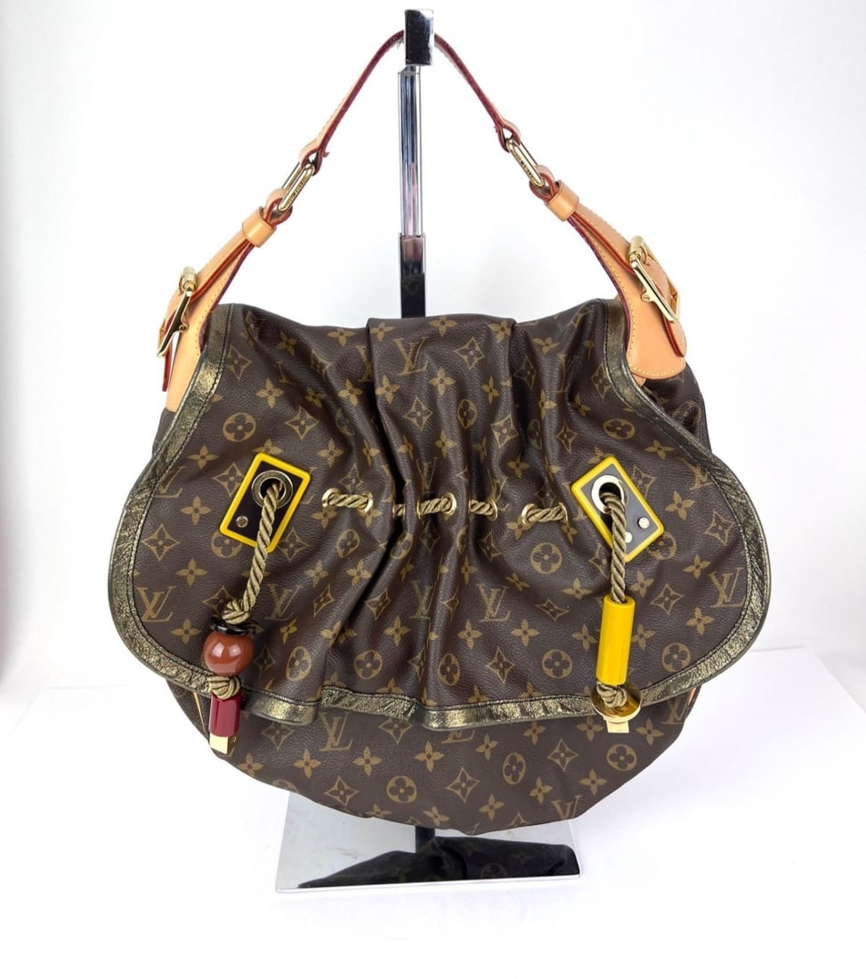 Kalahari GM Monogram Canvas Shoulder Bag by Louis Vuitton Limited Edition: Kalahari GM Monogram Canvas Shoulder Bag by Louis Vuitton Limited Edition The Louis Vuitton Monogram Kalahari GM Shoulder Bag is a limited edition designer accessory crafted from coated canvas with th