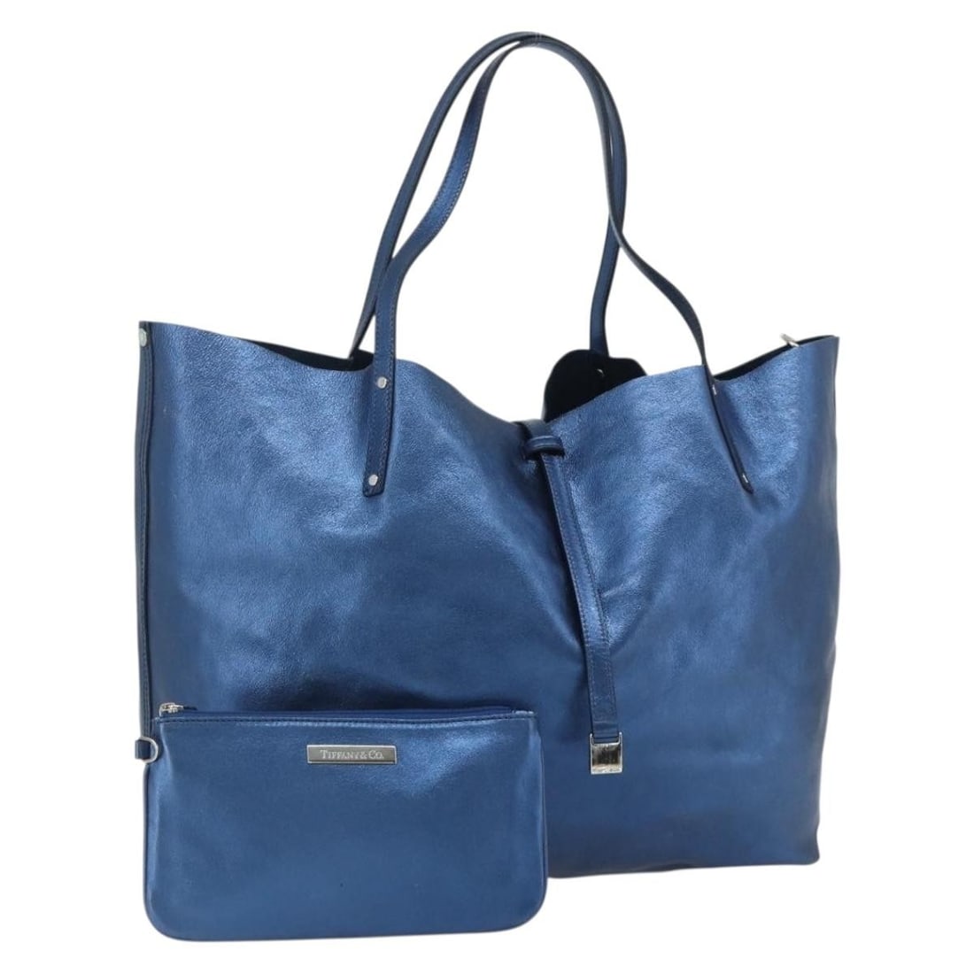 Tiffany Co Blue Leather Tote with Pouch Italy: Tiffany Co Blue Leather Tote with Pouch Italy This Tiffany & Co. tote bag is crafted from leather in a blue and silver color combination. Designed for women, it features a spacious main compartment an