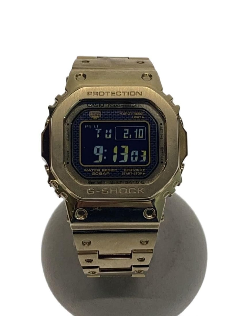 Casio G Shock Gold GMW B5000GD 9JF Men's Wristwatch: Casio G Shock Gold GMW B5000GD 9JF Men's Wristwatch This CASIO G-SHOCK GMW-B5000GD-9JF men's wristwatch features a durable gold-tone design and is crafted in Japan. The watch is pre-owned, graded as G