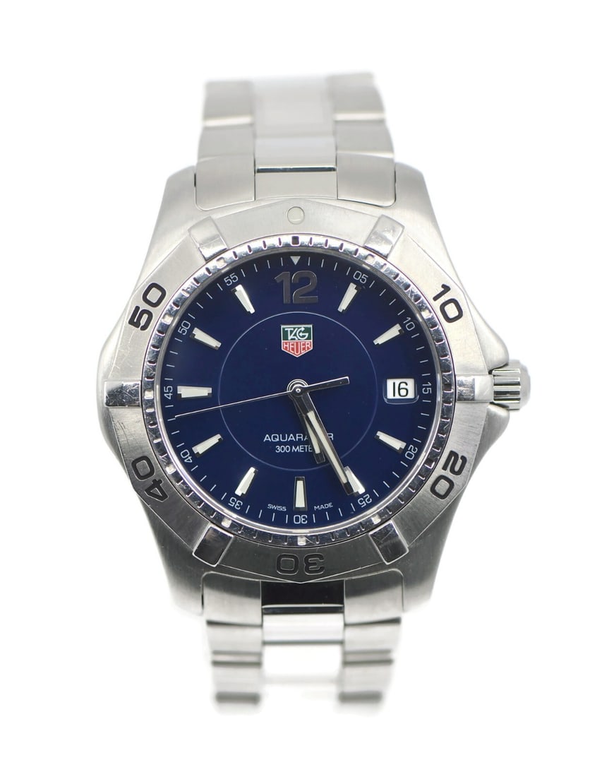 TAG Heuer Aquaracer Quartz Blue Dial Steel Wristwatch WAF1113: TAG Heuer Aquaracer Quartz Blue Dial Steel Wristwatch WAF1113 This TAG Heuer Aquaracer wristwatch features a stainless steel case and band, paired with a striking blue analog dial. Designed for men, i