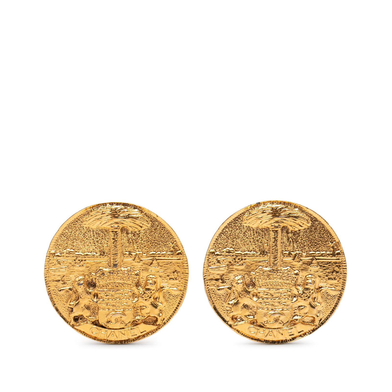 Chanel Crest Design Gold Plated Round Clip Earrings: Chanel Crest Design Gold Plated Round Clip Earrings These Chanel round clip-on earrings feature gold-plated metal bodies with a crest design. Made in France, they are a classic example of costume jewe