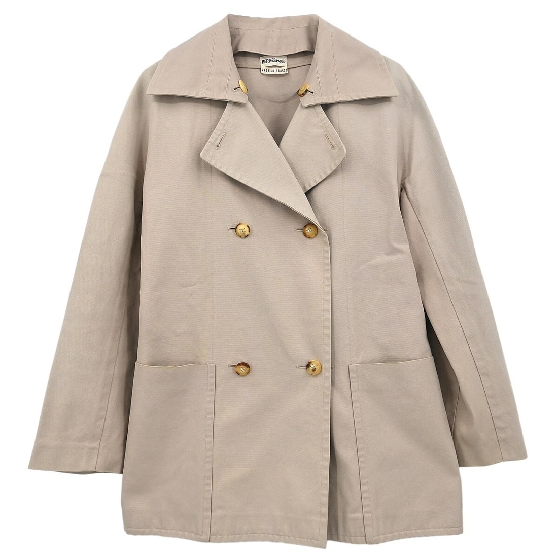 Hermes Vintage Beige Double Breasted Jacket Size 36: Hermes Vintage Beige Double Breasted Jacket Size 36 Elevate your wardrobe with this vintage Hermes Double Breasted Jacket in a classic beige color. Crafted from 100% cotton, this mid-length jacket fea