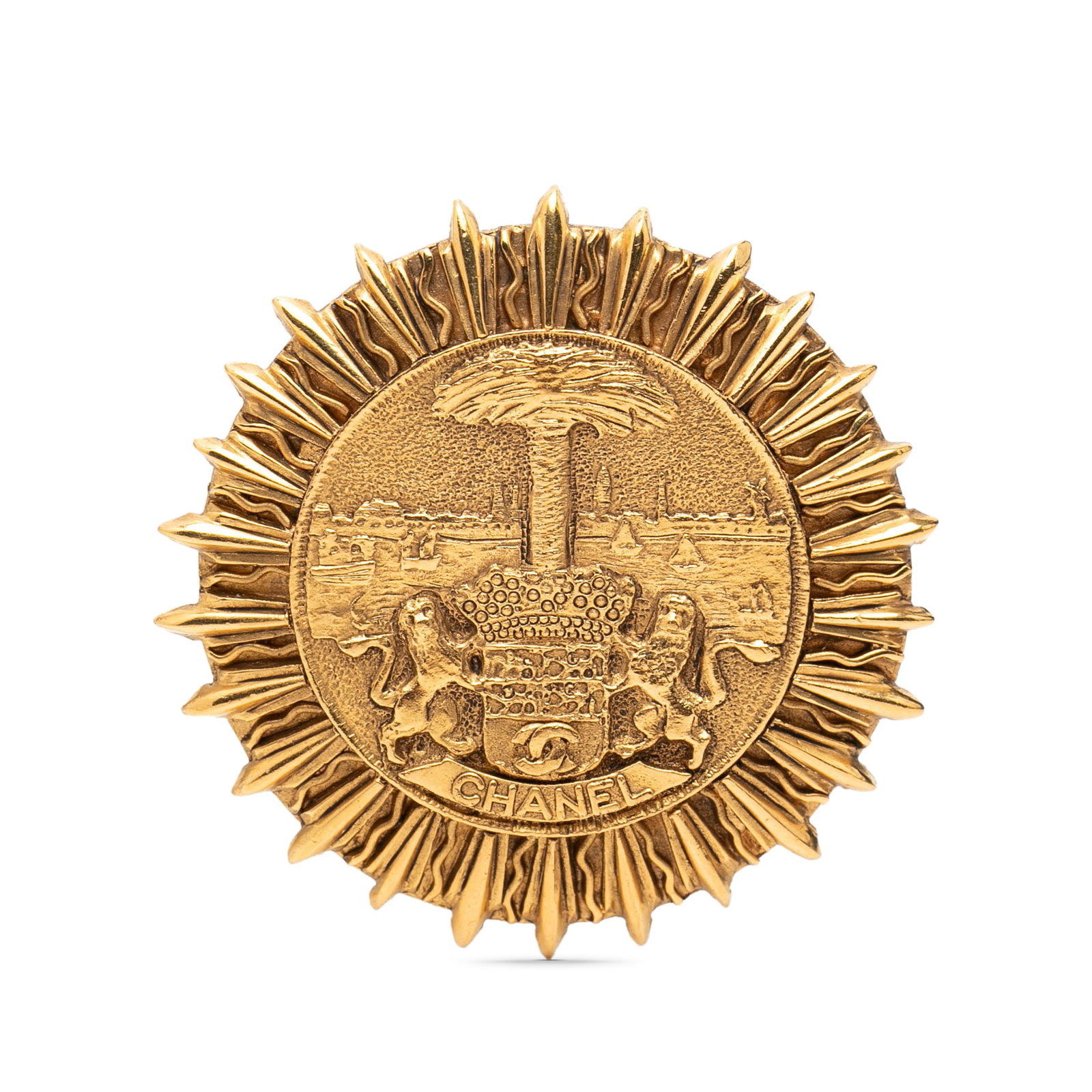 Chanel Gold Tone Metal Coat of Arms Brooch Pin France: Chanel Gold Tone Metal Coat of Arms Brooch Pin France This Chanel brooch features a gold-tone metal body with a coat of arms design and a secure back pin closure. Made in France, it is categorized as 