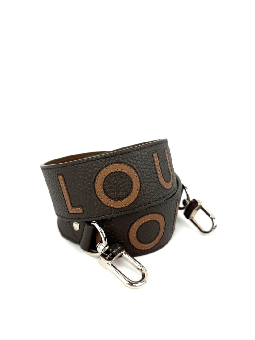 Louis Vuitton Taurillon Leather Brown Shoulder Strap with Box and Dust Bag: Louis Vuitton Taurillon Leather Brown Shoulder Strap with Box and Dust Bag This Louis Vuitton Bandouliere shoulder strap is crafted from pebbled brown leather and features a silver-tone lobster clasp 