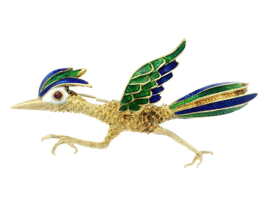 Vintage Yellow Gold Roadrunner Brooch with Ruby Eye and Enamel Detail: Vintage Yellow Gold Roadrunner Brooch with Ruby Eye and Enamel Detail Adorn yourself with this exquisite Vintage Yellow Gold Roadrunner Brooch, featuring intricate blue and green enamel detailing and 